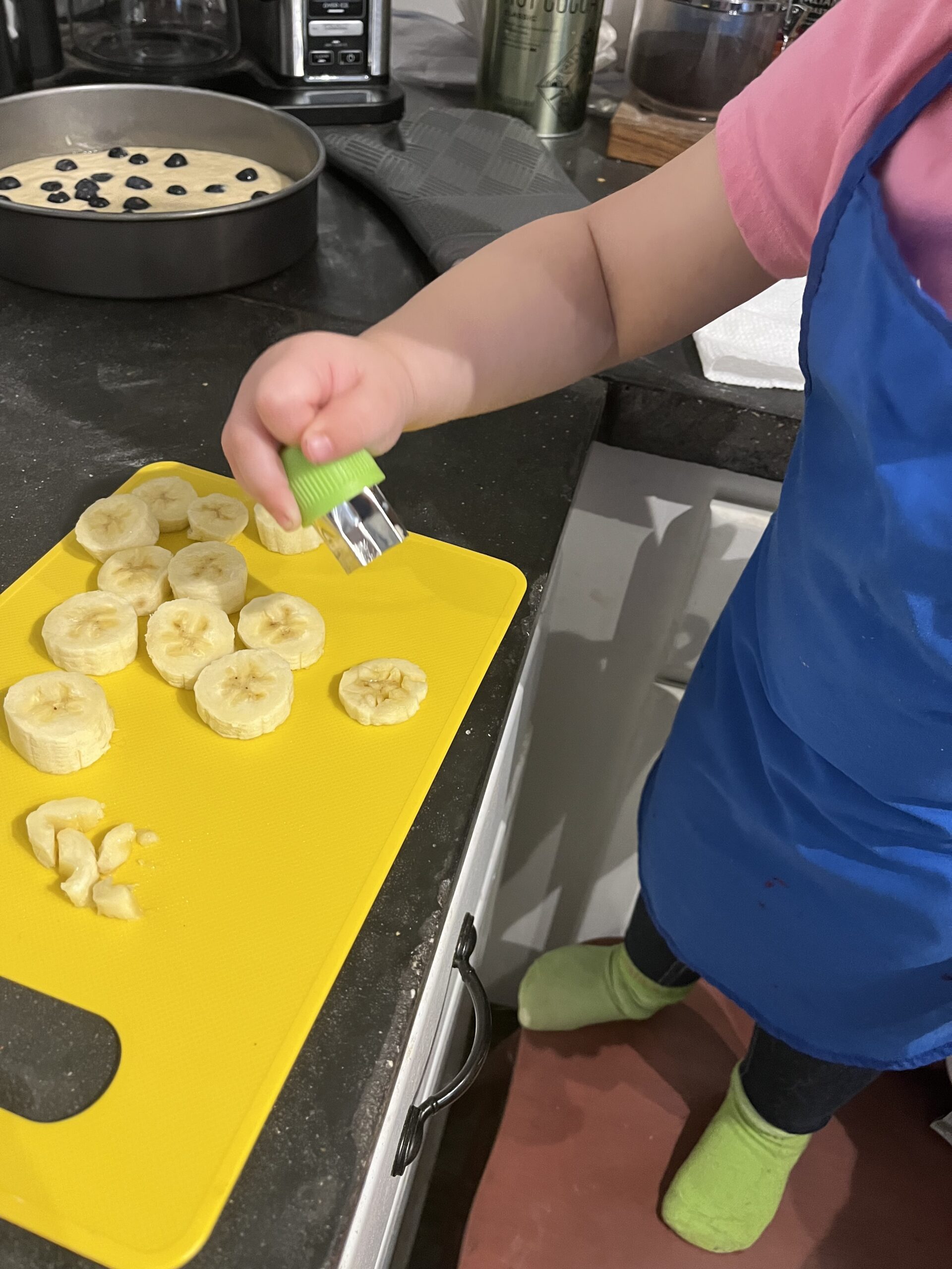 Toddle cutting shapes into bananas kitchen safety